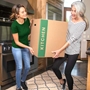 women carrying kitchen moving box