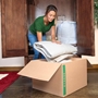 woman packing blankets into an x-large moving box